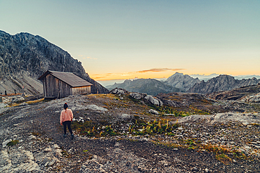 Woman enjoys sunrise in the mountains in Raetikon, Vorarlberg, Austria, Europe