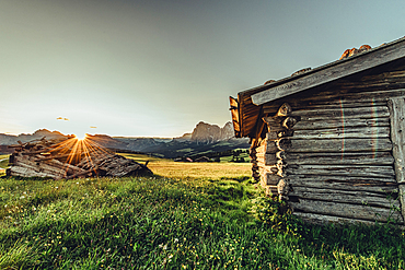 destroyed hut at sunrise on the Seiser Alm in South Tyrol, Italy, Europe;