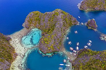 Aerial view of traditional Filipino Banca outrigger canoes lying in the lagoon near Lake Kayangan, Banuang Daan, Coron, Palawan, Philippines, Asia