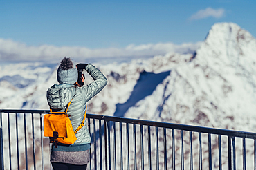 Woman with camera on the Corvatsch Glacier in the Engadin, Grisons, Switzerland, Europe