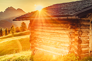 Hut at sunrise on the Seiser Alm in South Tyrol, Italy, Europe;