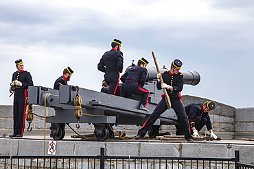 Firing historic cannons at Fort Henry Historic Site and Museum of Living History with uniformed performers known as the Fort Henry Guard performing British military life demonstrations and tours for visitors, Kingston, Ontario, Canada, North America