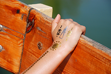 Golden temporary tattoo on the hand of a child