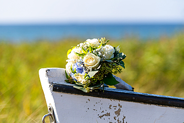 Bouquet of flowers with roses and hydrangeas on the tip of a wooden boat