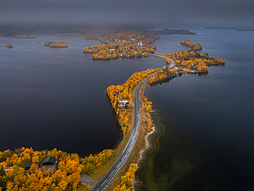 Road through Saxnäs along the Wilderness Road with islands in autumn in Lapland in Sweden from above