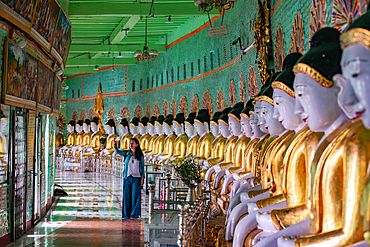 A woman takes a selfie at U Min Thonze Pagoda on Sagaing Hill in Myanmar