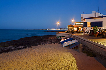 Boats and restaurant on the beach at dusk, Corralejo, Fuerteventura, Canary Islands, Spain, Europe