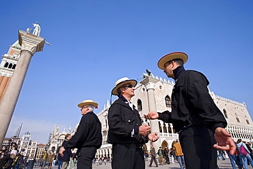 Gondoliers near the Doges Palace, Piazza San Marco, Venice, Veneto, Italy