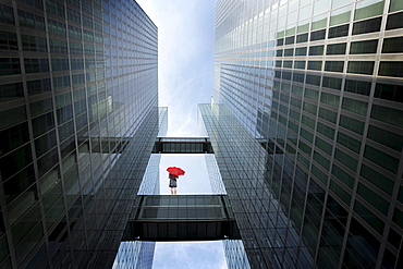 Woman with red umbrella between high-rise buildings, Munich, Bavaria, Germany (digital composite)