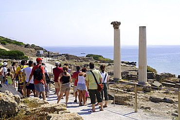 Tourists in front of roman excavation in the sunlight, antique town Tharros, Sardinia, Italy, Europe