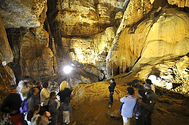 Tourists at the illuminated cave Grotta su Marmuri in the Gennargentu mountains, Sardinia, Italy, Europe