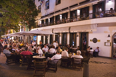 People sitting outside the Golden Gate Grand Cafe in the evening, Funchal, Madeira, Portugal