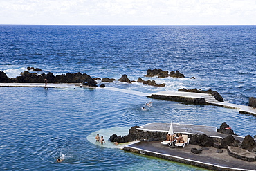 People enjoying a swim in the Natural Rock Pools, Porto Moniz, Madeira, Portugal