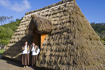 Women at Traditional A-framed Palheiro House Display at Madeira Theme Park, Santana, Madeira, Portugal