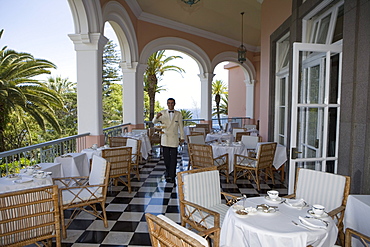 Waiter serves Afternoon Tea on the Terrace at Reid's Palace Hotel, Funchal, Madeira, Portugal