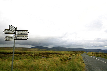 Signpost at The Old Military Road under clouded sky, Wicklow Mountain National Park, County Wicklow, Ireland, Europe