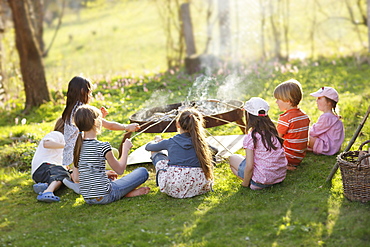 Children barbecueing sausages, Munsing, Bavaria, Germany