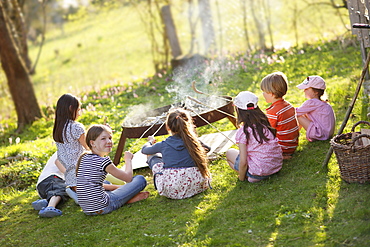 Children barbecueing sausages, Munsing, Bavaria, Germany