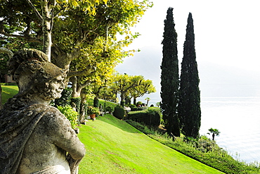 Sculptures and cypresses in park of Villa del Balbianello, Lenno, Lake Como, Lombardy, Italy