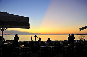 People at the promenade of Parikia at sunset, island of Paros, the Cyclades, Greece, Europe