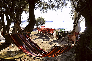 Hammock and cafe at the north beach between trees, Parikia, island of Paros, the Cyclades, Greece, Europe