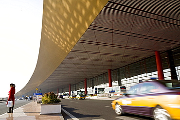 Woman and taxi in front of the International Airport Beijing, largest building in the world, Peking, China, Asia