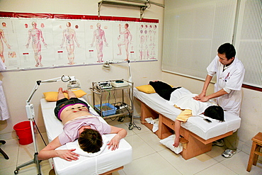 A doctor taking care of two patients, Xiamen, Fujian province, China, Asia