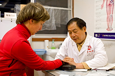 Chinese doctor examining german patient, Xiamen, Fujian, China, Asia