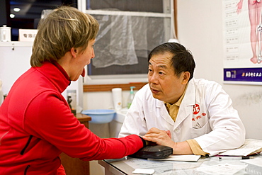 Chinese doctor examining german patient, Xiamen, Fujian, China, Asia