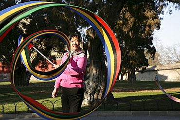 Chinese woman doing gymnastics at Tiantan Park, Beijing, Peking, China, Asia