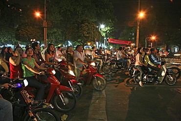 People driving scooters during the Tet festival at night, Saigon Ho Chi Minh City, Vietnam, Asia