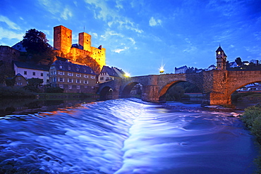 View over Lahn river with stone bridge to castle ruin, Runkel, Hesse, Germany