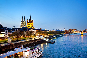 View over river Rhine to old town with cathedral and Great St. Martin church, Cologne, North Rhine-Westphalia, Germany