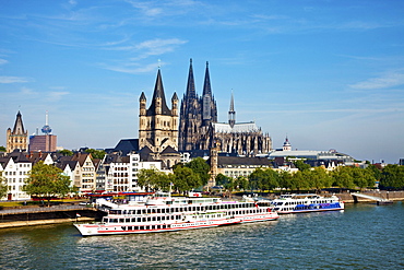 View over river Rhine to old town with cathedral and Great St. Martin church, Cologne, North Rhine-Westphalia, Germany