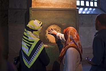 mystical sweating column of pourous marble, place the thumb in the hole and make a wish, Hagia Sophia, Istanbul, Turkey