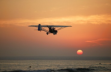 Ultralight plane flying over the beach of Es Trenc, Mallorca, Balearic Islands, Spain