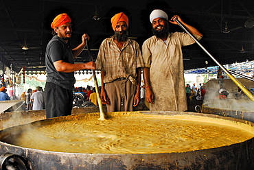 Golden Temple, three Sikh men with giant pot, free food for pilgrims, Sikh holy place, Amritsar, Punjab, India, Asia