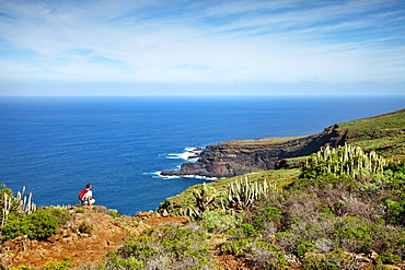 Hiker at the coast looking at the sea, Santo Domingo de Garafia, La Palma, Canary Islands, Spain, Europe