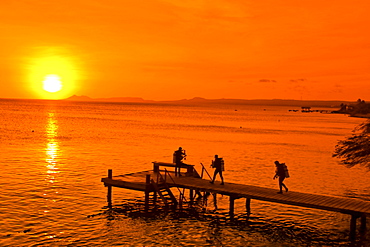 West Indies, Bonaire, sunset, pier, diver near Captain Don s Habitat, diving resort