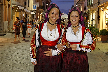 Italy Sardinia Olbia, women with traditional costumes on main street