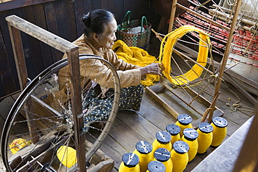 Old women of the Intha tribe working on a spinning wheel, Inle Lake, Shan State, Myanmar, Burma