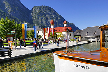 people walking on pier, with boat, St. Bartholomae, lake Koenigssee, Berchtesgaden range, National Park Berchtesgaden, Berchtesgaden, Upper Bavaria, Bavaria, Germany