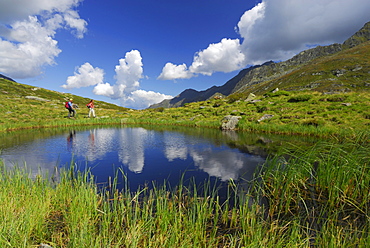 couple hiking near small lake, Stubaier Alpen range, Stubai, Tyrol, Austria