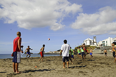 Teenagers playing football on the beach of Sao Roque, near Ponta Delgada, Sao Miguel, Azores, Portugal