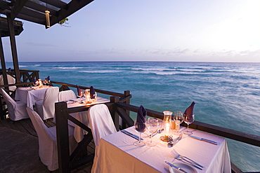 Terrace by the water's edge in the evening of the restaurant Josef's, St. Lawrence Gap, Barbados, Caribbean