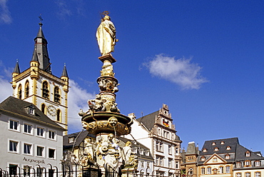 Sculpture on a fountain and houses under blue sky, Trier, Mosel, Rhineland-Palatinate, Germany