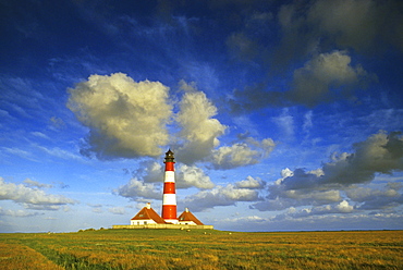 Westerhever lighthouse under cloudy sky, Eiderstedt peninsula, North Friesland, Schleswig-Holstein, Germany