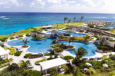 View over swimming pool area of the Crane Hotel, Atlantic Ocean in background, Barbados, Caribbean