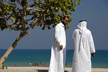 Two local men in front of the beach, Al Fujairah, United Arab Emirates