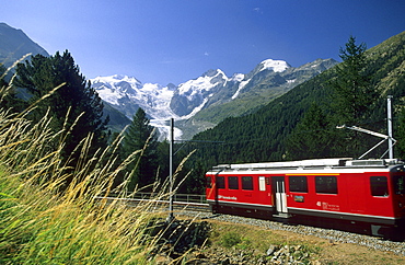 Red Train of Rhaetische Bahn in front of mountain range of Bellavista, Piz Argient, Crast Aguezza, Piz Bernina, Piz Prievlus and Piz Morteratsch, Ferrovia Raetia, Bernina range, Bernina, Morteratsch, Oberengadin, Engadin, Grisons, Switzerland